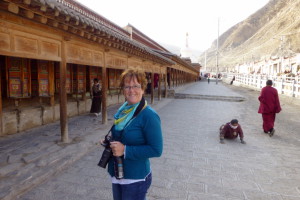 Jacqueline met links de gebedsmolens en rechts een iemand die de korlam doet